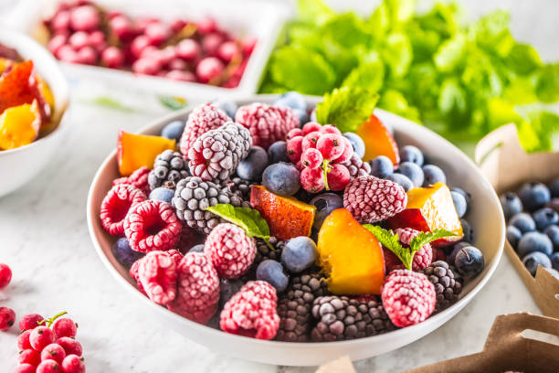 istock Frozen fruits blueberries blackberry raspberry red currant peach and herbs melissa 1160024291