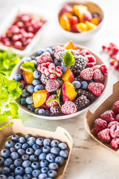 istock Frozen fruits blueberries blackberry raspberry red currant peach and herbs melissa 1160024331
