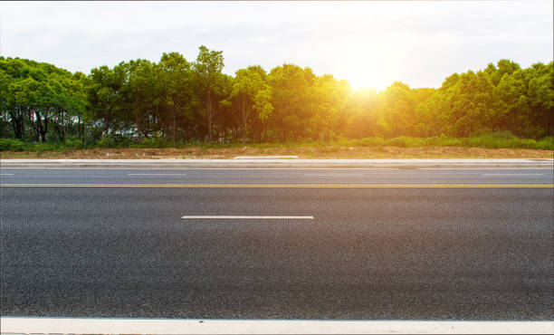 istock New asphalt roads, trees under blue sky and white clouds 1160025797