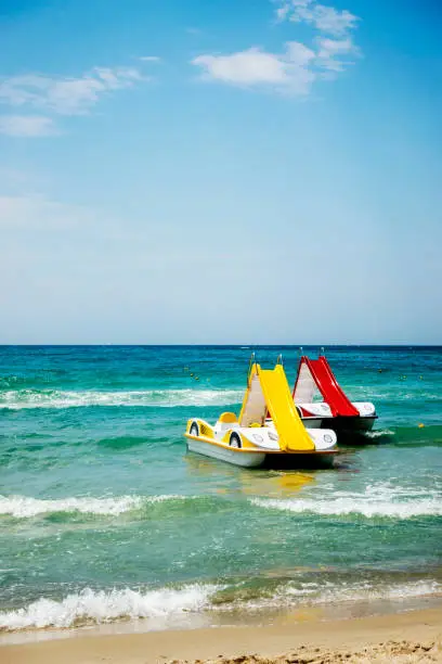 Two pedal-boats with water slides on the beach in Halkidiki, Greece.