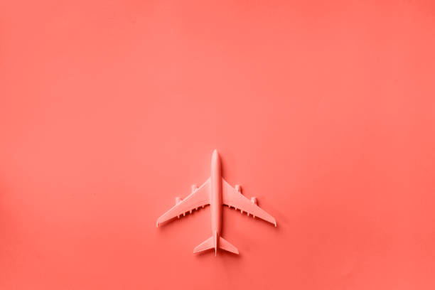 istock Creative layout. Top view of white model plane, airplane toy on pink pastel background. Flat lay with copy space. Trip or travel banner in trendy coral color 1160028206