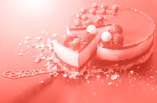 Delicious raspberry cake with fresh strawberries, raspberries, blueberry, currants and pistachios on trendy coral color background. Copy space. Banner.