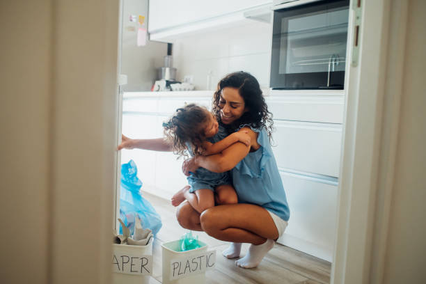 istock Mother and daughter hugging when recycling 1160028475