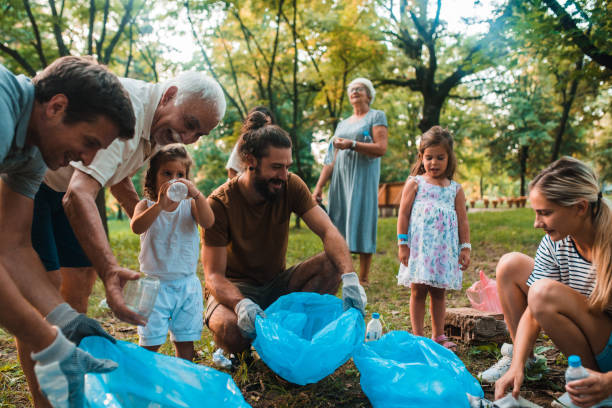 Family with children collecting garbage