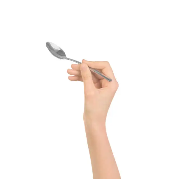 Photo of silver spoon in women hand isolated