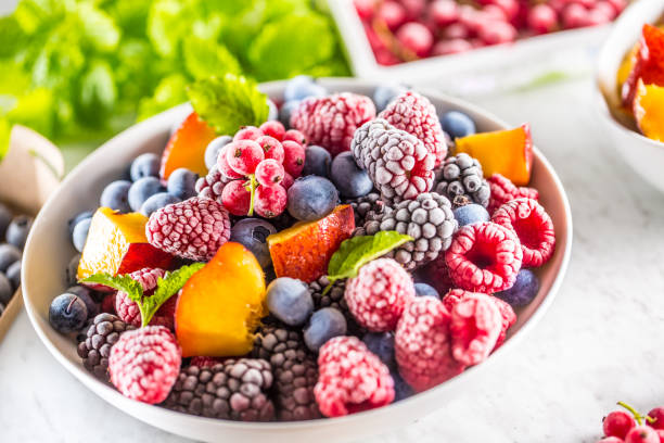 istock Frozen fruits blueberries blackberry raspberry red currant peach and herbs melissa 1160029264