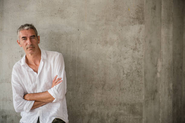 istock A casually dressed mature man standing outdoors, waiting for someone or something 1160030484