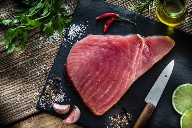 raw tuna steak on rustic wooden table - tuna tuna steak raw freshness imagens e fotografias de stock