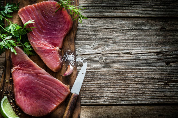 istock Two raw tuna steaks on rustic wooden table 1160030524