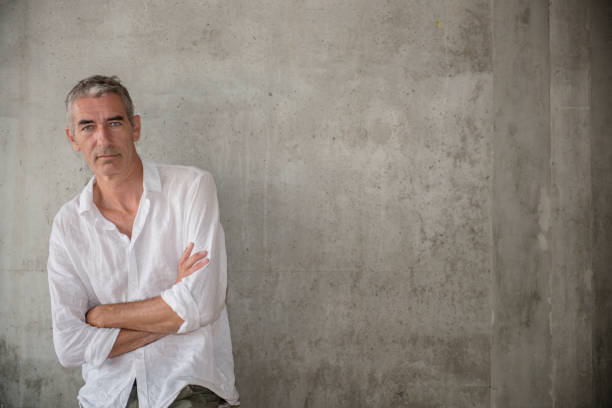 istock A casually dressed mature man standing outdoors, waiting for someone or something 1160030528