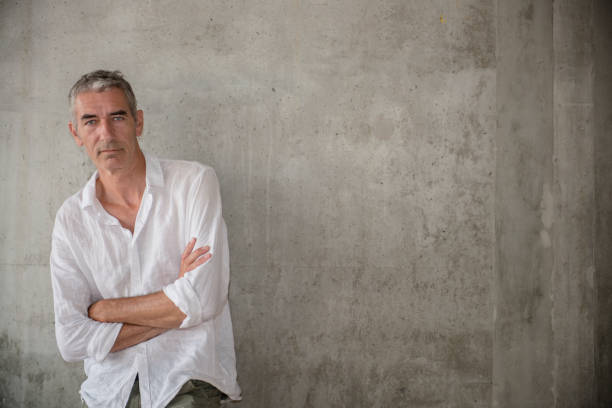 istock A casually dressed mature man standing outdoors, waiting for someone or something 1160030559