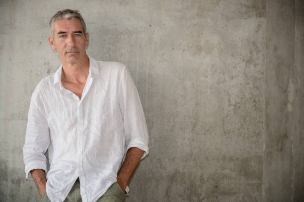 istock A casually dressed mature man standing outdoors, waiting for someone or something 1160030646
