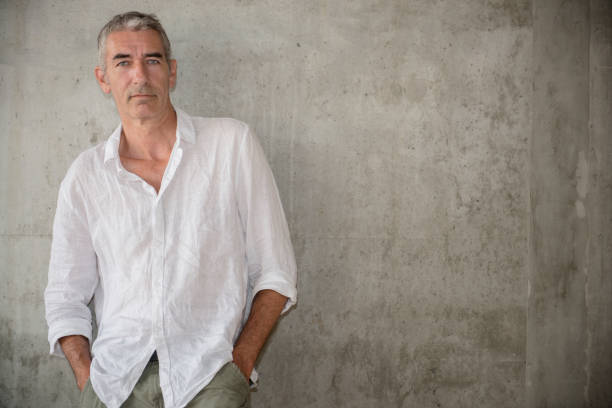 istock A casually dressed mature man standing outdoors, waiting for someone or something 1160030657