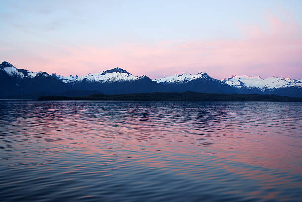 Pink sunset over the Sitkine ice field. Snow and ice accumulate in the ice field forming several major glaciers. Frederick Sound, Alaska, USA.