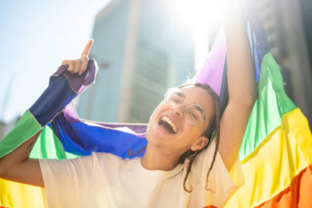 istock Happy man celebrating with rainbow flag during the LGBTQI parade 1160036075