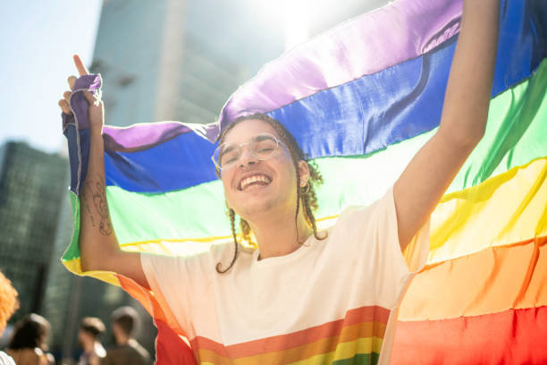 istock Happy man celebrating with rainbow flag during the LGBTQI parade 1160036183