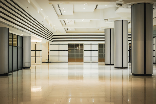 Empty long corridor and door in the modern office building.