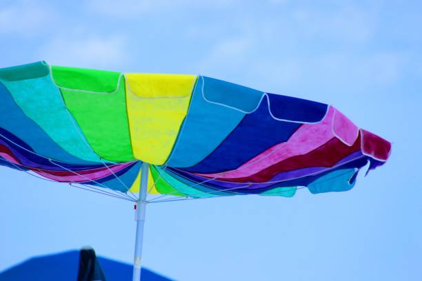 istock Colorful beach umbrella on sunny windy day. 1160037458