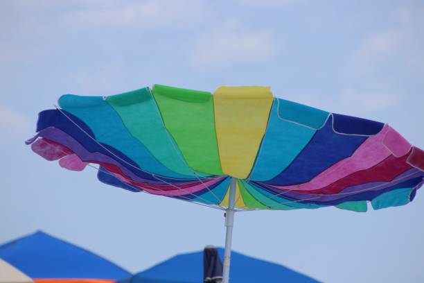 istock Colorful beach umbrella on sunny windy day. 1160037473