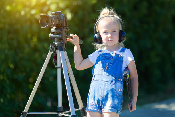 istock Child novice video blogger with a camera and a tripod. 1160037542