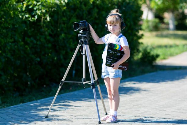 istock Child novice video blogger with a camera and a tripod. 1160037823