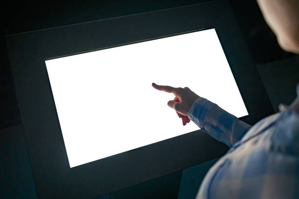 istock Woman touching interactive white blank touchscreen display kiosk at exhibition 1160039283