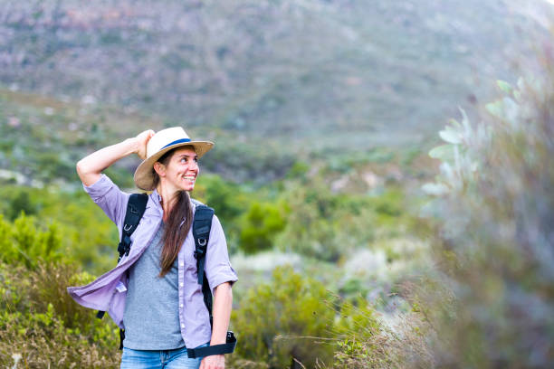 istock Happy smiling female with hat in nature looking sideways 1160039566