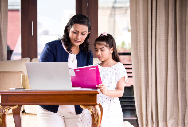 istock Mother helping daughter with homework 1160040320