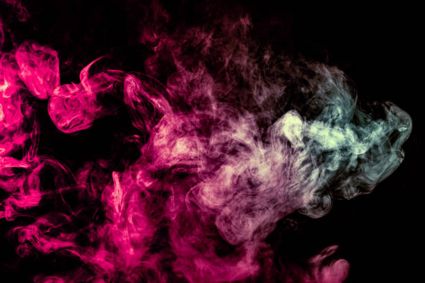 istock Colored background with winding clouds of smoke from patterns of different forms of pink, green and blue colors with tongues of flame on a black isolated background 1160040345