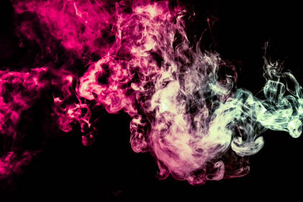 istock Colored background with winding clouds of smoke from patterns of different forms of pink, green and blue colors with tongues of flame on a black isolated background 1160040588