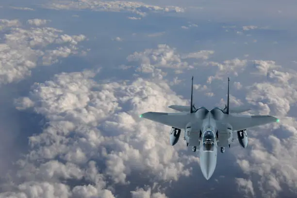 F-15 Figter Jet flying over clouds