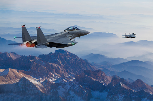 Military helicopter flying over the mountain peaks. 3d Rendering Aircraft. Aerial Landscape from British Columbia, Canada.