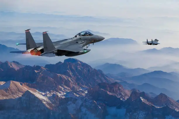 F-15 Eagle Fighter Jets flying above mountains