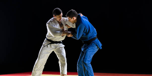 istock Male Judo Players Competing During Match 1160043691