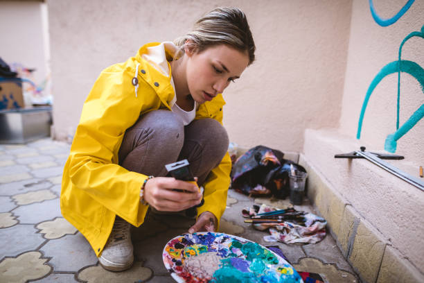 Female artist preparing paint on the palette
