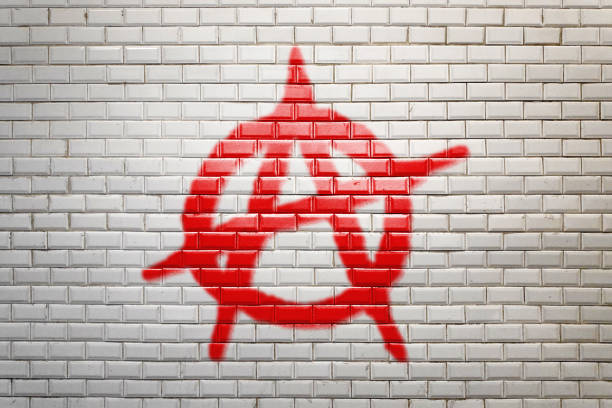 símbolo da anarquia dos grafittis do falso na parede de tijolo - símbolo da anarquia - fotografias e filmes do acervo