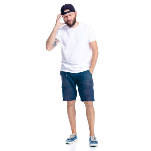 istock Man in shorts and cap standing thinking nervous 1160045028