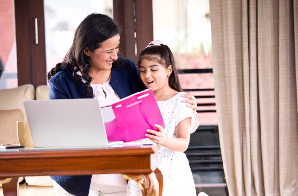 istock Mother helping daughter with homework 1160045969