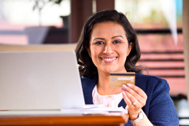 istock Woman using credit card at home 1160046188