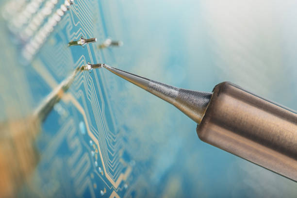 Soldering of electronic circuit board with electronic components. Soldering station. Engineers repair circuit board with soldering iron.