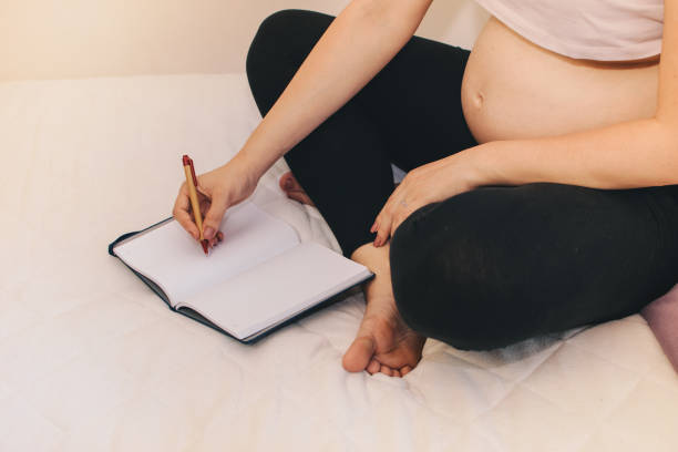 istock Pregnant woman keeping a pregnancy diary 1160047651