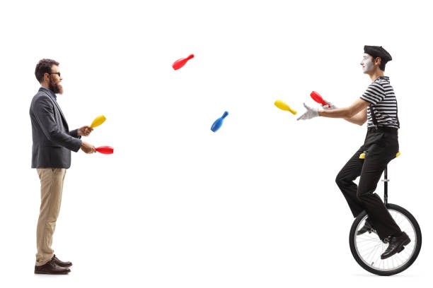 istock Mime on a unicycle juggling with a man 1160049356