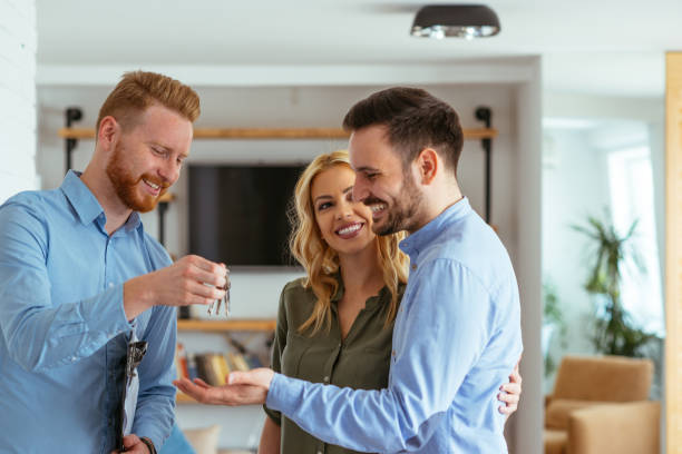 This is all we ever wanted! Our dream came true! Shot of young satisfied couple became owners of the new house. real estate agent male stock pictures, royalty-free photos & images