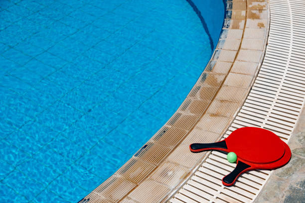 Bat and ball game besdie the pool