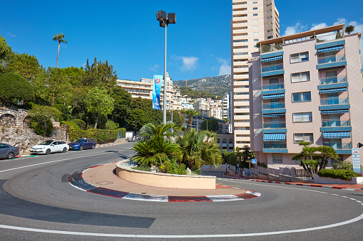 MONTE CARLO, MONACO - AUGUST 21, 2016: Monte Carlo empty street curve with formula one red and white signs in a sunny summer day in Monte Carlo, Monaco.