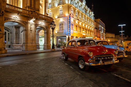 Havana, Cuba - May 17, 2019: Classic Old American Car in the streets of the Old Havana City during a vibrant night after sunset.