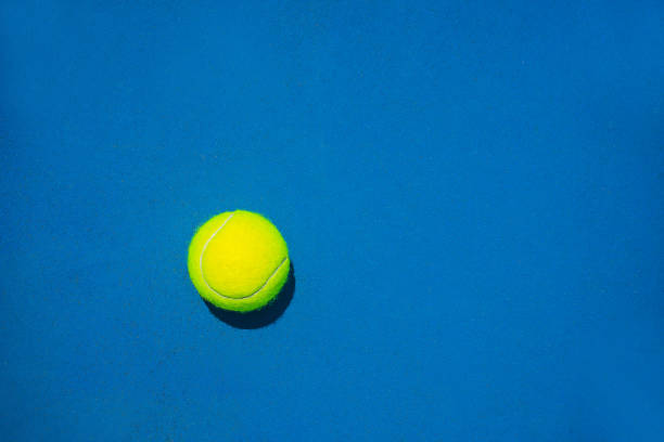 tennis ball on blue background. - tennis court tennis ball racket imagens e fotografias de stock