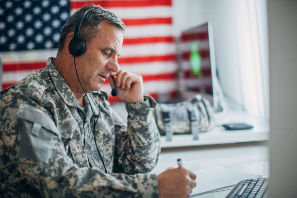 istock Army soldier wearing headphones and writing notes 1160056665