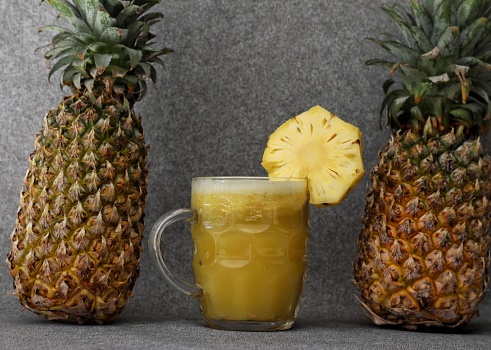 Pineapple juice on Grey backdrop