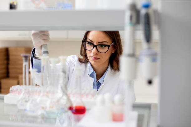 istock Young woman working in laboratory on some experiment 1160058260